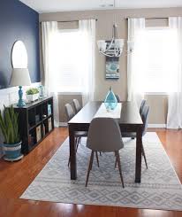 Mid Century Modern Dining Room With Dark Blue Accent Wall And Brass Mirror Blue Accent Walls Mid Century Modern Dining Room Mid Century Modern Dining