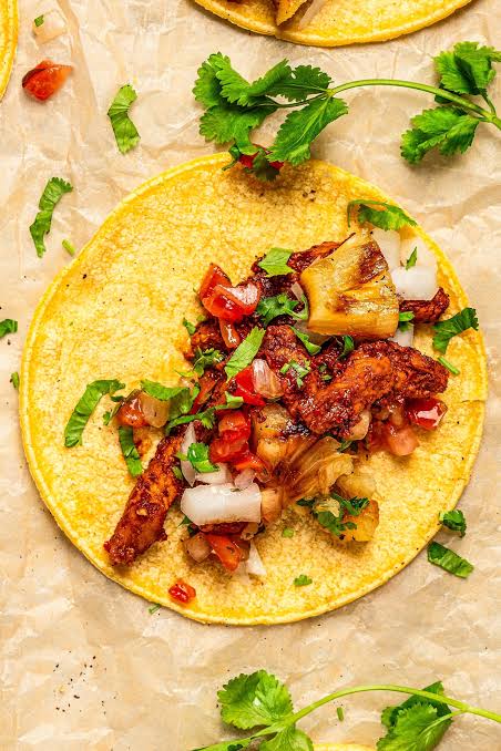 Key ingredients for al pastor marinade: achiote paste, guajillo chiles, garlic and pineapple