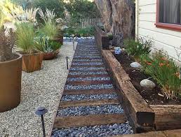 At the time of these retaining wall pictures their driveway had not yet been paved, so the pictures really show how our retaining wall design and construction added a lot of useable driveway space, compared to the old railroad tie retaining walls we replaced. Transform Your Yard With A Railroad Tie Retaining Wall
