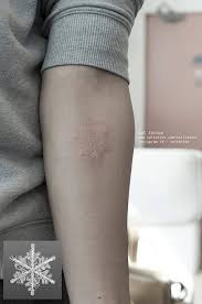 These tattoos are incredibly subtle, especially on lighter skin, and can take on many forms. White Ink Snowflake Tattoo On The Left Inner Forearm