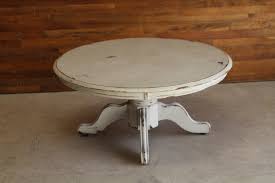 This piece is painted wood with polychrome floral decor; Vintage Farm Table Rentals Round White Coffee Table