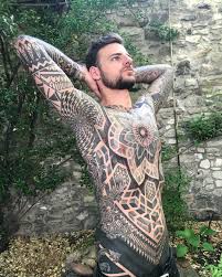 Unleash the beast of mystery in the depths of an all black tattoo. Matt Black S Ornamental Tattoos Inkppl Mens Body Tattoos Body Suit Tattoo Black Ink Tattoos