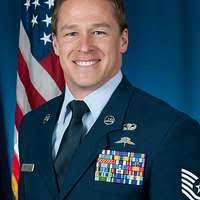 Air Force Lt. Gen. Ken Wilsbach, left, smiles after