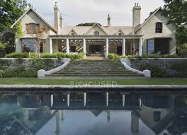 The dining room is equipped with a modern fully automatic coffee machine. Luxury Modern House Against Pool Daytime Real Estate Stock Photo 199380018