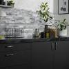 Stacked stone backsplash and stainless steel range hood. 1