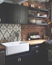 Cozy Kitchen With Black Cabinetry Exposed Brick Walls Butcher Block Countertop And White Apron Sink Bold Kitchen Industrial Kitchen Design Kitchen Design
