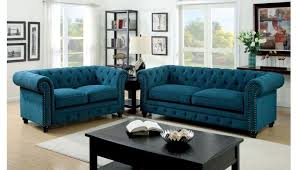#living room #tufted sofa #sofa #plum sofa #side table #home accessories #head bust #table lmap #coffee table #drapes #interior design #interior how can you go wrong with this tufted chesterfield leather sofa? Bernadette Blue Fabric Tufted Sofa