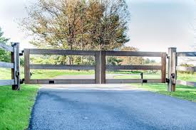 Fence rails can be installed between or across posts, using hangers, nails or screws to fasten them. Post And Rail Automatic Wooden Driveway Gate Fence Design Wooden Gates Driveway Driveway Gate Diy