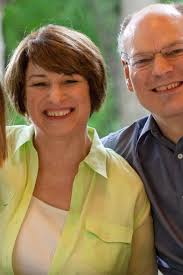 The Latest: Klobuchar's husband tests positive for virus