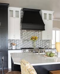 Wonderfully Appointed Black And White Kitchen Is Fitted With A Black Hood F Kitchen Cabinets Black And White Backsplash For White Cabinets White Kitchen Rustic