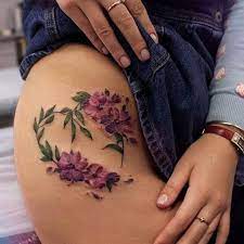 An Example Of A Different Style Of Purple Orchids These Classic Tattoo Designed Flowers Circle And Curl To Bring Gorgeous Tattoos Tattoos Stretch Mark Tattoo