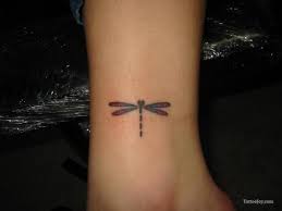 This tattoo shows a bunch of flowers around dragonfly and a butterfly. Dragonfly Tattoos For Men Ideas And Inspiration For Guys Small Dragonfly Tattoo Dragonfly Tattoo Dragonfly Tattoo Design