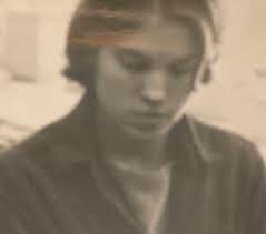 This young lady has a strong resemblance to my son. Guess who? 19ish. Most  of the time her hair was not so short. Perms were popular but this was a  fashion cut.