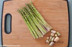 Place the asparagus into a mixing bowl, and drizzle with the olive oil. How To Trim Asparagus 3 Ways Frugal Family Home