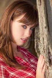 Girl Looking at Camera through the Trees Stock Photo