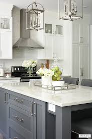 Beautiful fall kitchen decor with vintage wood bread boards and glass demijohns from boxwood avenue. White And Grey Kitchen A Hardware Update Citrineliving Modern Grey Kitchen White Kitchen Decor White Modern Kitchen