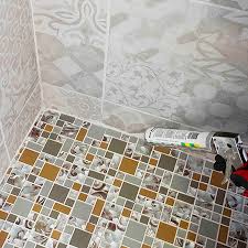 Travertine tiles are a beautiful choice for bathroom countertops. Home Dzine Bathrooms Install Glass Mosaics On Shower Floor