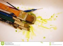 cleaning paint brushes in the sink by