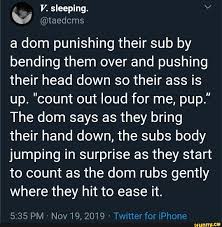 A dom punishing their sub by bending them over and pushing their head down  so their