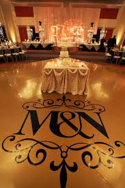 Gold Vinyl Dance Floor With Black Decal Of Bride And Groom S Initials Yanni Design Studio Wedding Decorations Dance Floor Vinyl Wedding Stage