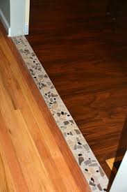 Instead of standard square tile, consider rectangular plank tile. Accent Tile Transition Between The Hardwood In The Dining Room And The Vinyl Planking In The Kitchen Transition Flooring Flooring Living Room Flooring