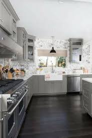 Kitchen With Gray Cabinets White Farmhouse Sink And Very Dark Wood Flooring Woodfloorin Hardwood Floors In Kitchen Grey Wood Floors Kitchen Kitchen Flooring