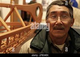 ** ADVANCE FOR WEEKEND SEPT. 21-22 ** Noah Andrew Sr. of Kwigillingok,  Alaska stands next to a Yup'ik qayaq, or kayak, in Bethel, Alaska, in  September 2007. An exhibit of about 80 artifacts, many of them loaned from  far-off museums, opened to the ...
