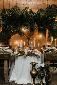 It's the perfect base for a big installation where you're adding in tropical blooms in pinks, oranges, and yellows, tying together an otherwise interesting mix—or even as the back of a bouquet. Dramatic Tropical Monstera Palm Arch Backdrop Wedding Reception Moore Tropical Wedding Centerpieces Tropical Wedding Reception Sweetheart Table Wedding