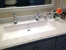 long bathroom sink with two faucets and