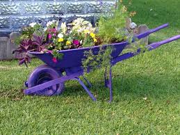 Old Wheelbarrow Spray Paint A Few Plants And I Have New Flower Bed Wheelbarrow Planter Wheelbarrow Front Yard Garden Design