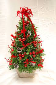 A Boxwood Christmas Tree Christmas Flower Arrangements Christmas Floral Arrangements Christmas Arrangements