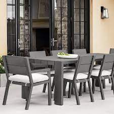 This modern outdoor dining set includes a rectangular dining table and six slatted chairs, two of which are armchairs. Larnaca Outdoor Metal Dining Table Williams Sonoma In 2021 Metal Dining Table Modern Outdoor Dining Table Modern Outdoor Dining