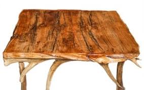 The base is an industrial lifting mechanism that allows the table to be raised and lowered equally at two points by turning one hand wheel, this unique feature allows it to function as both a coffee table and an eating surface. Lot Art Oversized Mesquite Coffee Table With Elk Antler Base