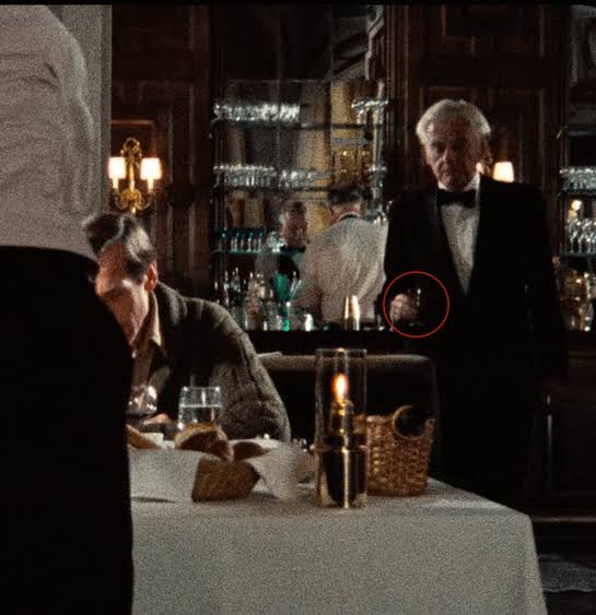 In "My Dinner with Andre" (1981) the waiter wanted to serve the amaretto  before it was ordered. Then he finally serves it after Wally gives his  speech about the future/science/omens etc. :