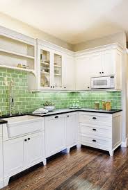 The hunter green cabinets and white subway backsplash tiles up to the ceiling with a choice of a black bar table and chairs are a. 20 Chic Kitchen Backsplash Ideas Tile Designs For Kitchen Backsplashes