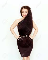 There is a side parting done with short fringes that are swept. Beautiful Stylish Brunette Girl With Long And Thick Hair Dress Of Hair Creative Hairstyle The Concept Of Fashion And Style A Young Elegant Woman Is Smiling And Looking At The Camera Stock