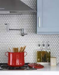 Maybe you would like to learn more about one of these? Browse Diy Archives On Remodelista Penny Round Tiles Blue Kitchen Cabinets Round Tile Backsplash
