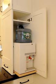 The Water Cooler Is Concealed Inside A Cabinet Easily Accessible Via A Roll Out Shelf Kitchen Appliance Storage Wooden Cabinets Water Dispenser