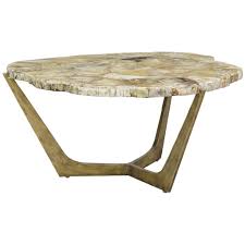 The silvester coffee table is a striking piece that will instantly add some texture to your living space with its petrified wood top and wide iron base. Palecek Petrified Wood Tripod Coffee Table Coffee Tables Benjamin Rugs Furniture