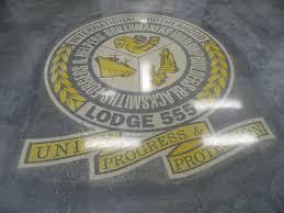 A Stenciled Concrete Floor By Mirror Image Concrete Polishing Great Way To Display Your Company Log Stenciled Concrete Floor Concrete Floors Stencil Concrete