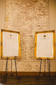 gold ivory wedding seating charts on big gold frames and