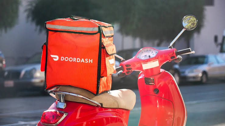 Red DoorDash bag on red scooter