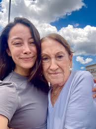 Hey there! Could someone help me open my eyes more, if possible, and maybe  clear my bags? Pretty please? They're very sensitive and I love this photo  of my grandma and me.