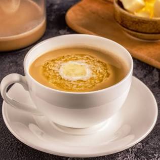Blending ghee into hot coffee creates a rich emulsion that fuels brain function, AI generated