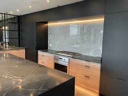 This sleek modern kitchen design incorporates white, silver and beautiful timber flooring. Sleek Modern Kitchen Mdm Design Studio