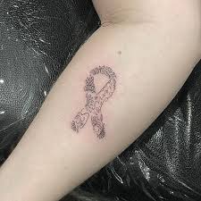 A pair of hands together in prayer is wrapped in a pink cancer ribbon tattoo. Cancer Ribbon 80 Of The Most Popular Tattoo Designs That Will Never Go Out Of Style Popsugar Beauty