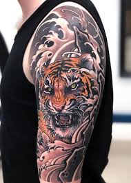 These powerful creatures are solitary hunters and are usually depicted with teeth bared in aggressive postures often surrounded by bamboo. 125 Best Japanese Tattoos For Men Cool Designs Ideas Meanings 2021 Japanese Tiger Tattoo Tiger Tattoo Sleeve Japanese Tattoos For Men