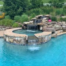 Just like it sounds, a waterfall spills out from a horizontal spout placed on a tiled or decorative wall near the pool. Swimming Pool Waterfalls Pool Waterfalls Mt Airy Clarksville Potomac Md Rowan Landscape Pools