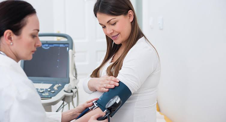 Image result for pregnant women checking blood pressure",nari