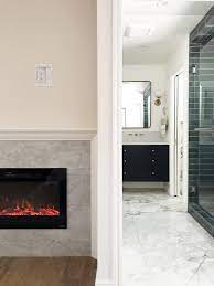 A corner fireplace adds dimension and a seating area to the bedroom, and a ribbon fireplace can run the length of the room and effective warm the space without increasing the heating bills. How To Diy A Built In Electric Fireplace Chris Loves Julia